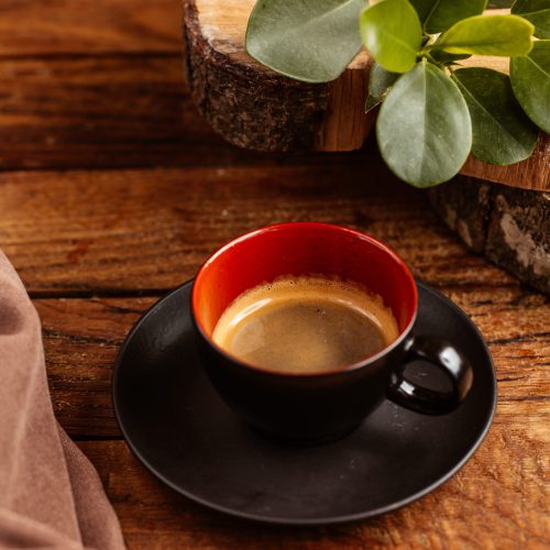 top view cup coffee half empty inside black cup brown wooden table drink coffee liquid